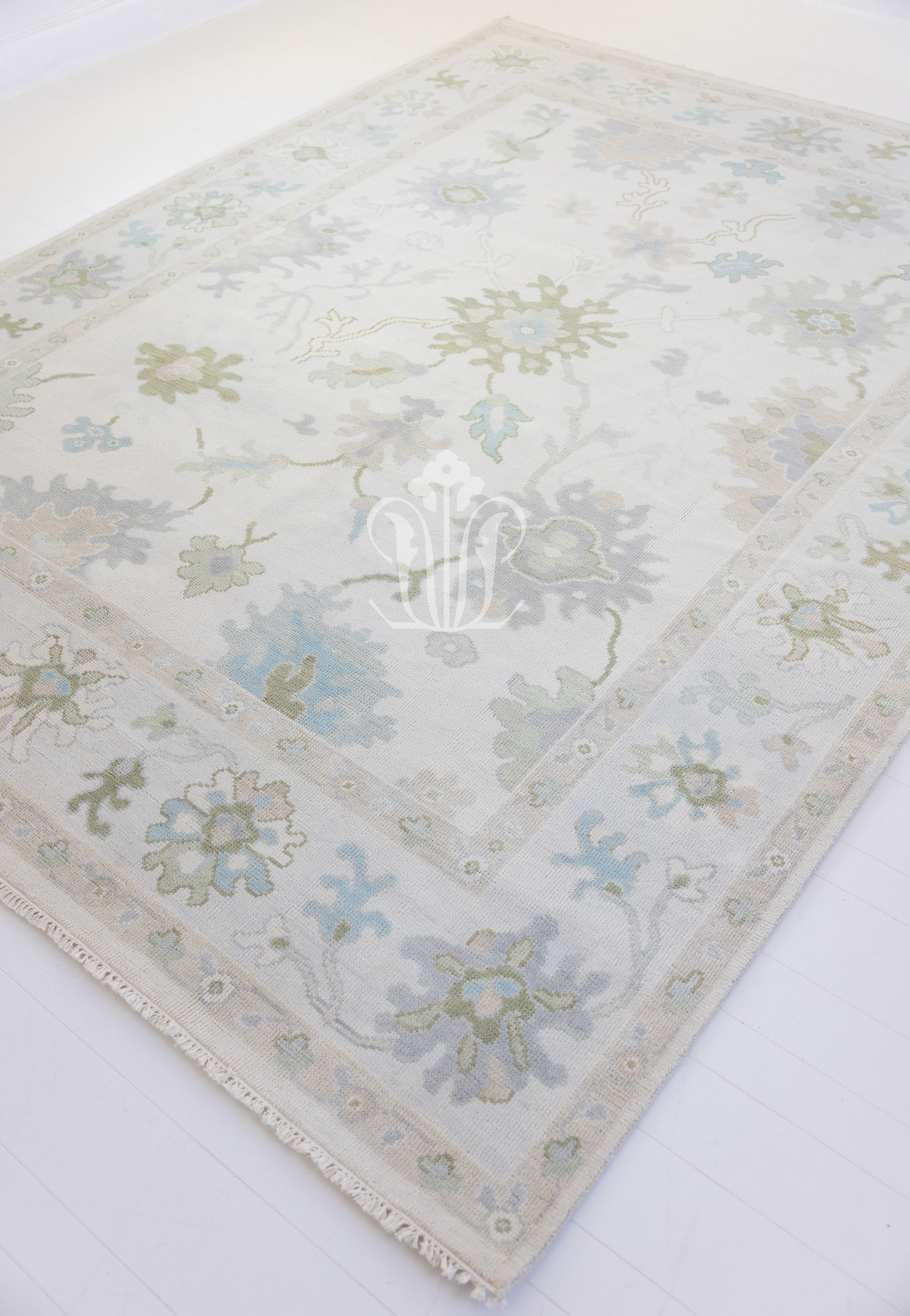 Opal hand-knotted wool rug featuring a traditional Oushak pattern