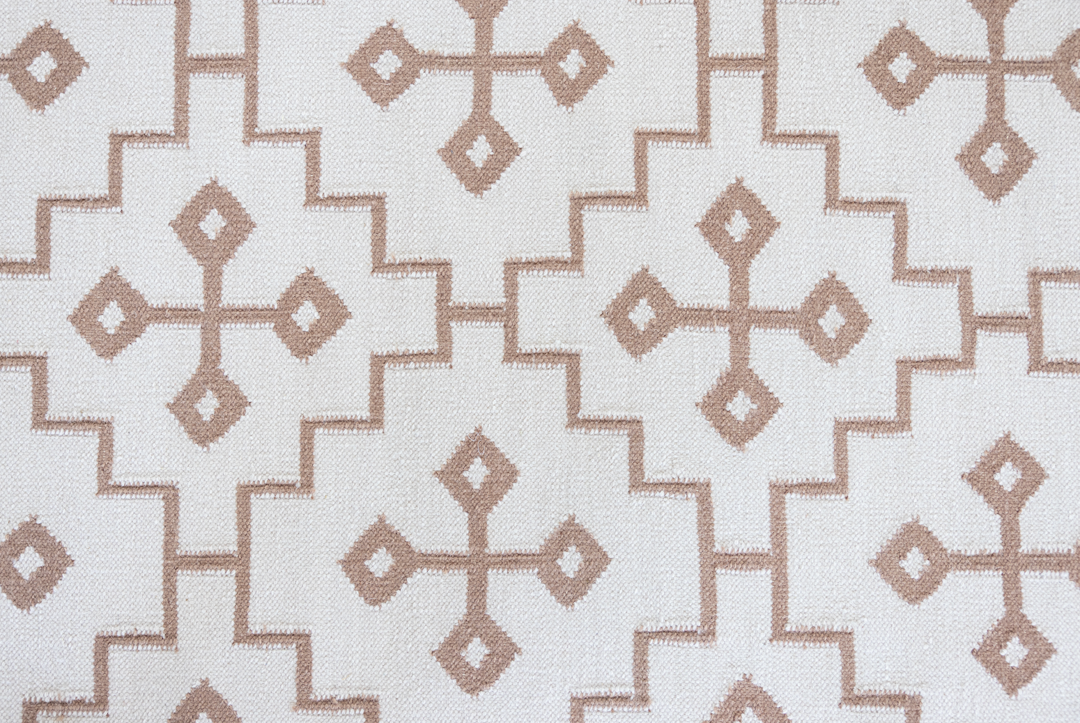 Orchid Geometric Flatweave Rug with a blush beige geometric pattern on a soft pink-beige background.