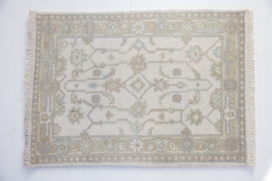 Hand-knotted wool rug with classic Oushak pattern in ivory, sky blue, and taupe – Pearl Mini Rug by Locust Lane Rugs