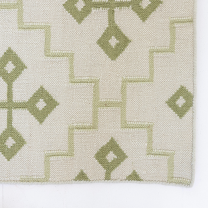 Close-up of the Pistachio Green Geometric Flatweave Rug highlighting its handwoven wool texture.