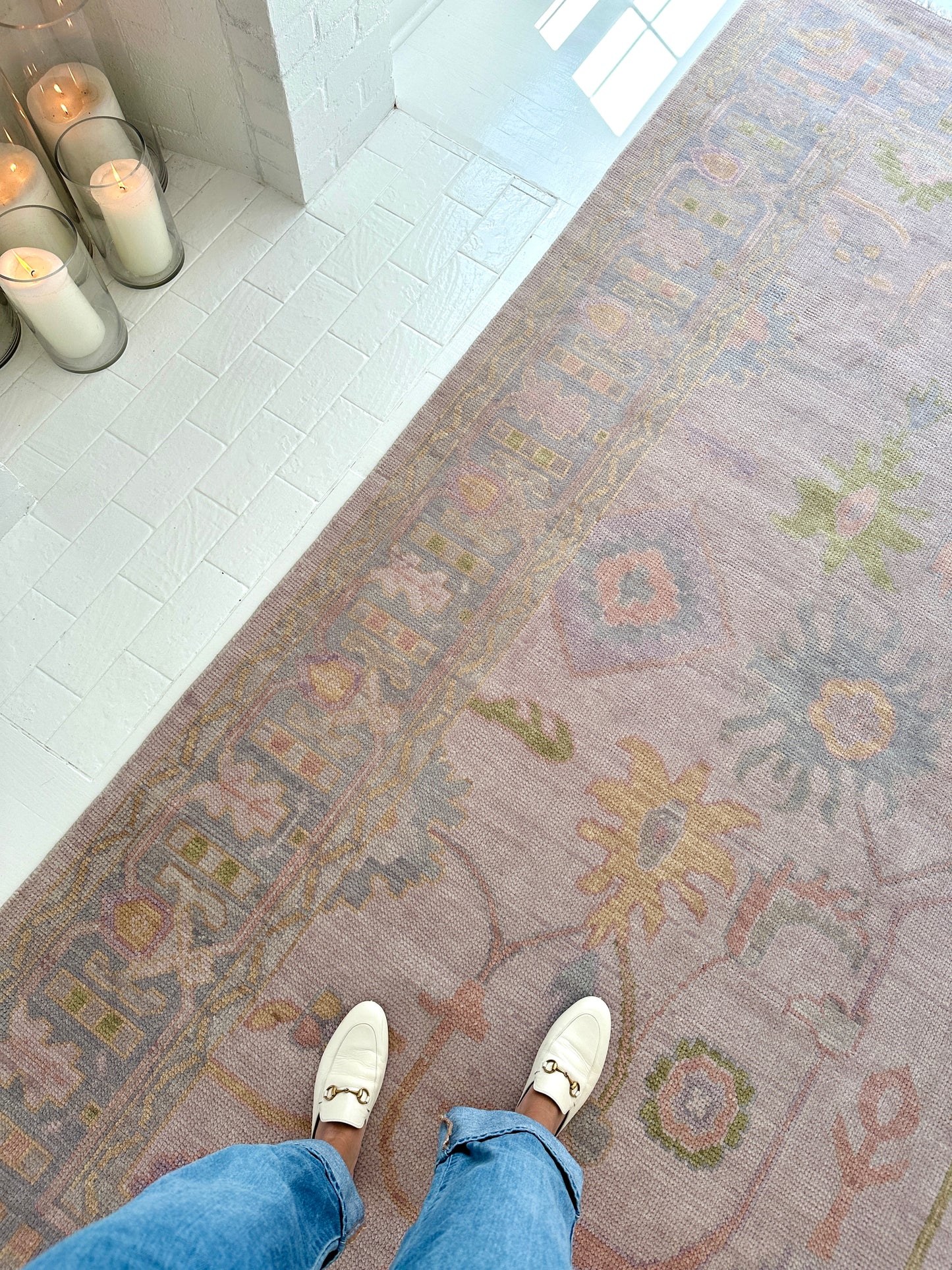 Hand-knotted wool rug in soft lavender and blush tones with sage and peach accents. The Rose Rug from Locust Lane features a delicate floral-inspired pattern that blends modern pastel hues with timeless craftsmanship.