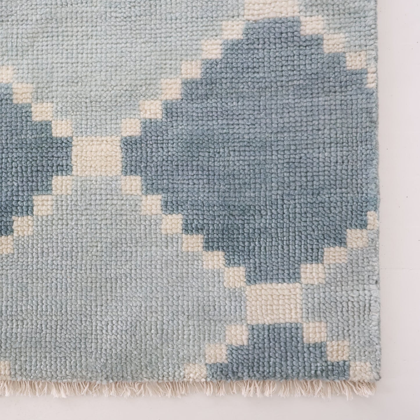 Corner detail of the Sadie Blue Mist hand-knotted geometric wool rug