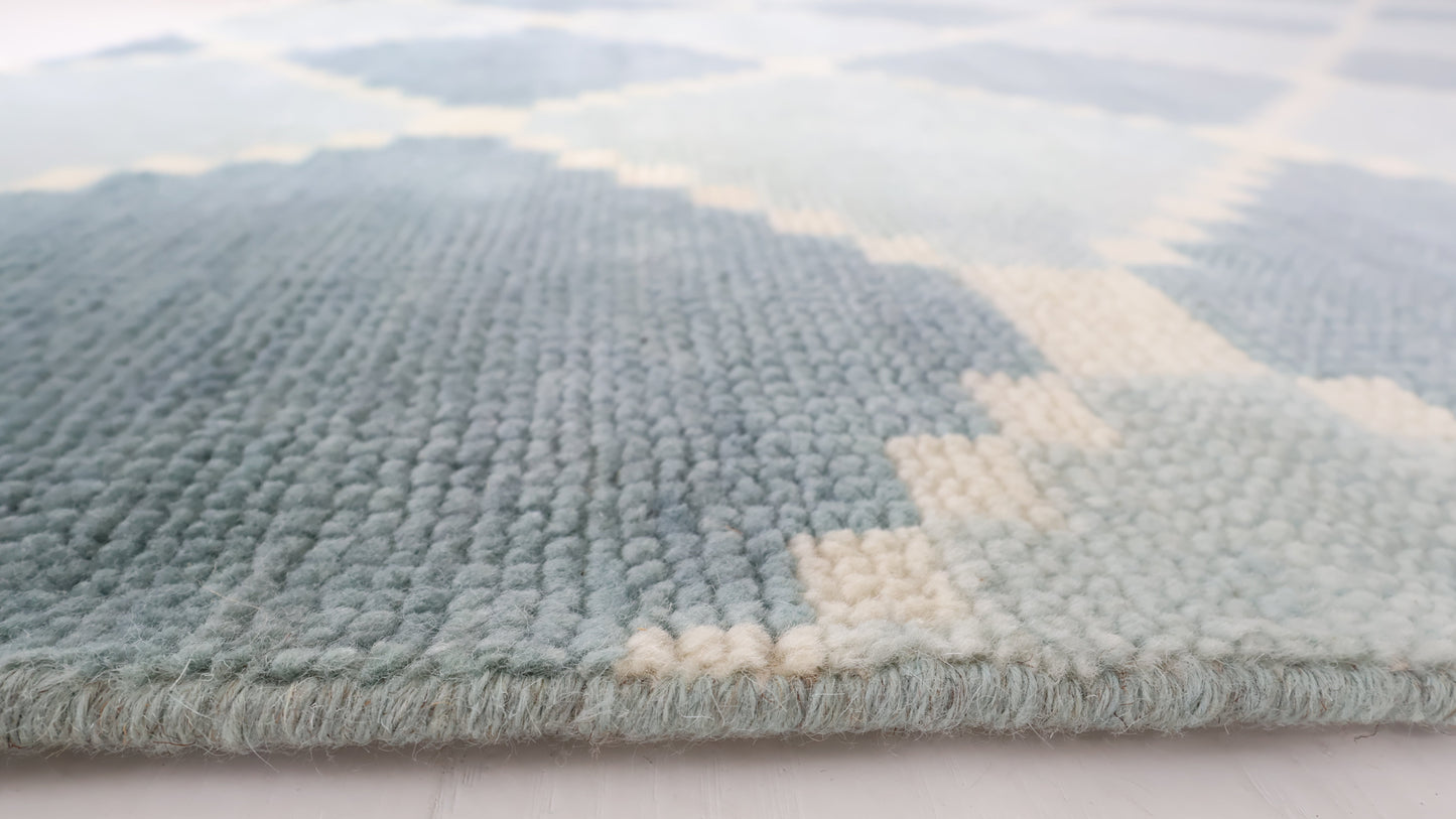 Close-up of the Sadie Blue Mist hand-knotted geometric wool rug showing its texture