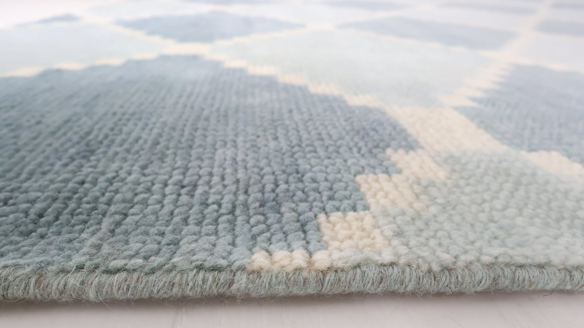 Close-up of the Sadie Blue Mist hand-knotted geometric wool rug showing its texture