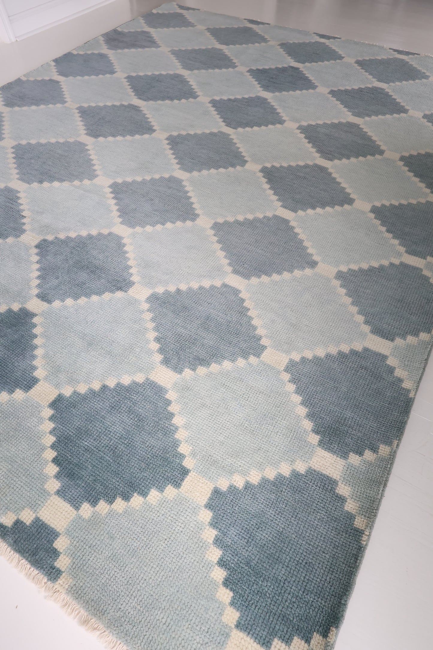 Full view of the Sadie Blue Mist hand-knotted geometric wool rug