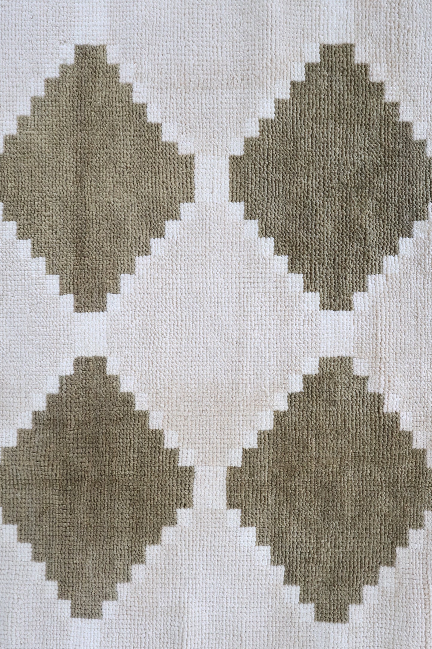 Close-up of the Sadie in Moss hand-knotted geometric wool rug