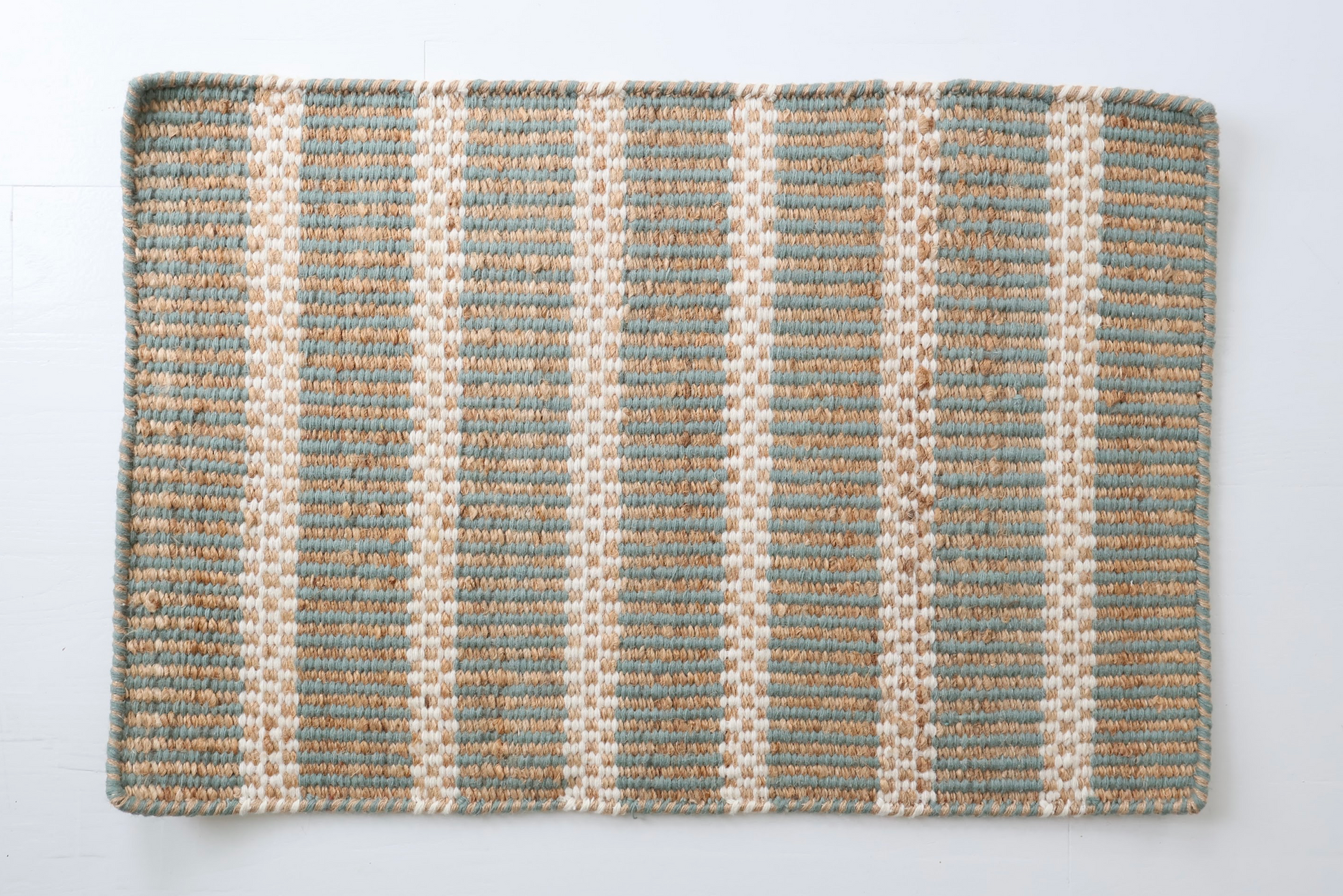 Sea Blue Jute & Wool Mini Rug featuring soft blue stripes woven with natural jute and wool fibers.