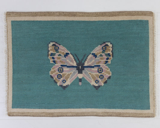 Hand-knotted wool rug featuring a butterfly motif on a turquoise background with ivory border – Turquoise Butterfly Mini Rug by Locust Lane Rugs