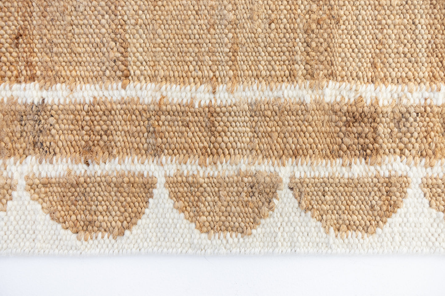Handwoven jute and wool rug in natural tones with a crisp white scalloped border – White Scalloped Edge Rug by Locust Lane Rugs