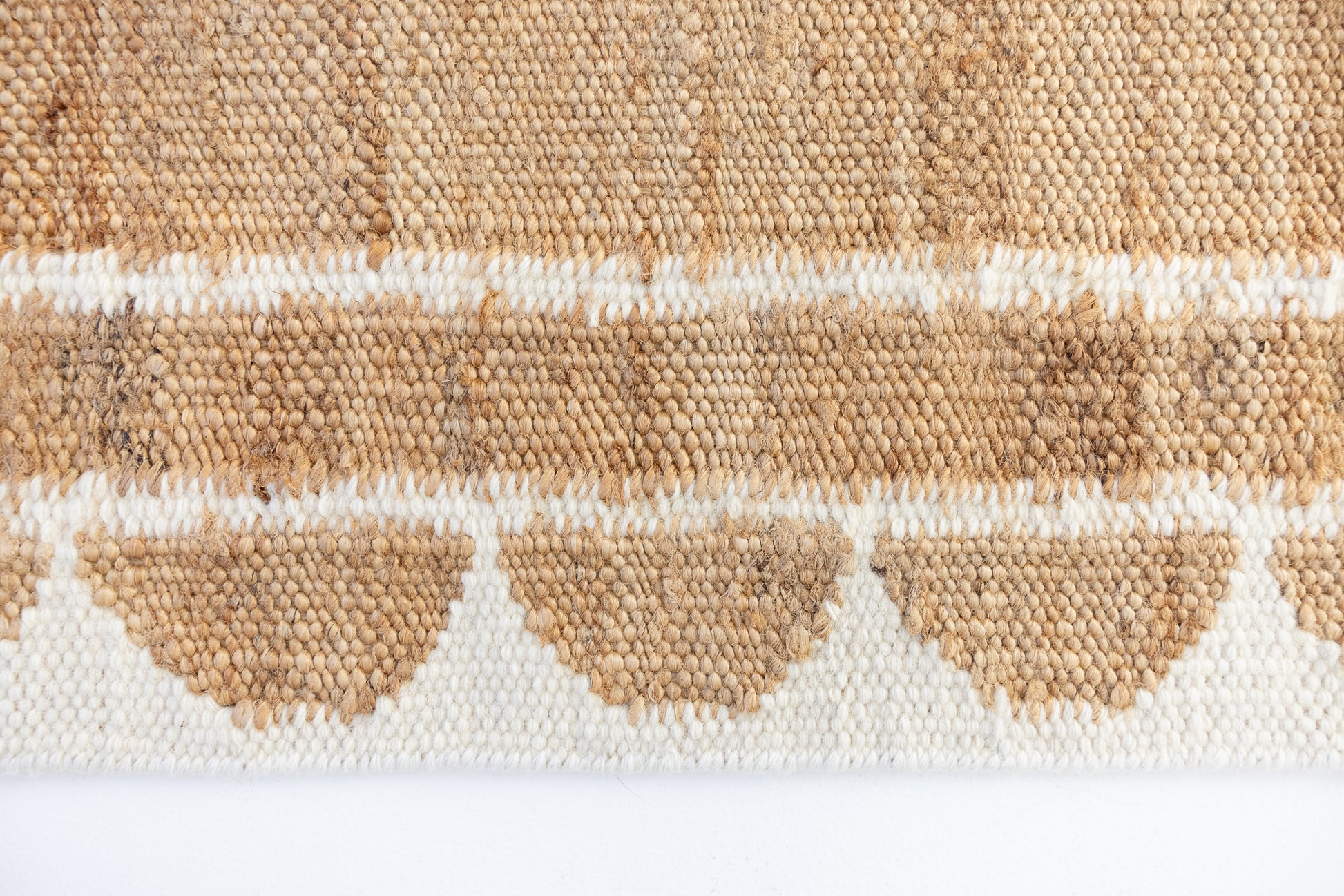 Handwoven jute and wool rug in natural tones with a crisp white scalloped border – White Scalloped Edge Rug by Locust Lane Rugs