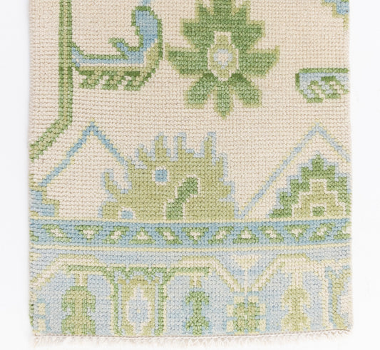 Handknotted wool rug sample in soft green, sky blue, and ivory with traditional Oushak floral motifs – Emogene Rug Sample by Locust Lane Rugs